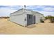 Shipping container building with an air conditioner and gravel, sitting in the desert at 53404 W Candlelight Rd, Maricopa, AZ 85139