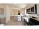 Updated kitchen featuring stainless steel appliances and sleek countertops with an open design at 53404 W Candlelight Rd, Maricopa, AZ 85139