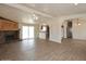 Open-concept living room with fireplace, wood floors, and view into the kitchen and dining area at 53404 W Candlelight Rd, Maricopa, AZ 85139