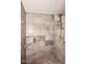 Tiled shower with overhead and handheld shower heads plus convenient corner shelving at 53404 W Candlelight Rd, Maricopa, AZ 85139