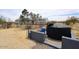 Well with concrete enclosure, black water tank and a house in the background at 53404 W Candlelight Rd, Maricopa, AZ 85139