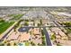 Aerial view showcasing a neighborhood with varied home styles, landscaping, and community layout at 5446 S Sandstone Ct, Gilbert, AZ 85298