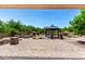 Beautiful backyard featuring a gazebo, fire pit, and decorative rock landscaping at 5446 S Sandstone Ct, Gilbert, AZ 85298