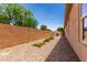Gravel backyard featuring a block wall, planter boxes, and potential for outdoor customization at 5446 S Sandstone Ct, Gilbert, AZ 85298