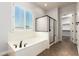 Bathroom showcasing a soaking tub, glass shower, and tile flooring at 5446 S Sandstone Ct, Gilbert, AZ 85298