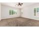 Spacious bedroom with plush carpeting, plantation shutters, and abundant natural light at 5446 S Sandstone Ct, Gilbert, AZ 85298