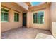 Charming courtyard featuring tan stucco walls, neutral trim, and beautiful tiled flooring at 5446 S Sandstone Ct, Gilbert, AZ 85298