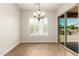 Bright dining nook with chandelier, plantation shutters, and sliding glass doors to access the patio at 5446 S Sandstone Ct, Gilbert, AZ 85298
