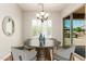 Charming dining nook with modern chandelier, plantation shutters, and access to the outdoor patio at 5446 S Sandstone Ct, Gilbert, AZ 85298