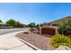 Charming community entrance sign with stone accents, lush landscaping, and well-maintained surroundings at 5446 S Sandstone Ct, Gilbert, AZ 85298