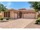 Beautiful desert home featuring a tile roof, stone accents, and a spacious three-car garage at 5446 S Sandstone Ct, Gilbert, AZ 85298