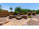 Fire pit with seating area in the backyard of the property at 5446 S Sandstone Ct, Gilbert, AZ 85298