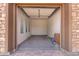 Garage features brick flooring, light neutral walls and a single window at 5446 S Sandstone Ct, Gilbert, AZ 85298