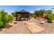 Backyard view of a gazebo with landscaping, rocks, and decorative grasses at 5446 S Sandstone Ct, Gilbert, AZ 85298