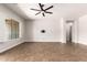 Bright, open living room with a ceiling fan and neutral color palette and plenty of natural light at 5446 S Sandstone Ct, Gilbert, AZ 85298