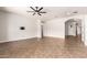 Bright, open living room with a ceiling fan and neutral color palette with direct access to front entry at 5446 S Sandstone Ct, Gilbert, AZ 85298
