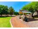 Shaded park gazebo with seating and walking path, surrounded by lush greenery at 5446 S Sandstone Ct, Gilbert, AZ 85298
