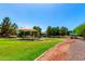 Community playground with sunshade, play equipment, and a grassy area for recreation at 5446 S Sandstone Ct, Gilbert, AZ 85298