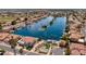 Aerial view of neighborhood with lake, palm trees, basketball court and lush landscaping at 579 N Mondel Dr, Gilbert, AZ 85233