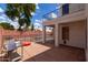 Backyard with patio, pool, privacy fence, and mature trees, creating an ideal outdoor living space at 579 N Mondel Dr, Gilbert, AZ 85233