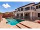 Backyard features a sparkling pool and covered patio, perfect for outdoor living and entertaining at 579 N Mondel Dr, Gilbert, AZ 85233