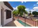 Balcony view overlooking neighborhood and pool, with lush trees under a sunny, partly cloudy sky at 579 N Mondel Dr, Gilbert, AZ 85233