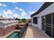 Balcony view with a pool, gazebo, and surrounding neighborhood under a bright, partly cloudy sky at 579 N Mondel Dr, Gilbert, AZ 85233