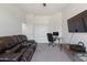 Bedroom featuring a sofa, desk, TV, and carpet, ideal for a multi-purpose space at 579 N Mondel Dr, Gilbert, AZ 85233