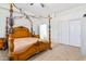 Spacious bedroom featuring a decorative wooden canopy bed and a large closet, offering comfortable living space at 579 N Mondel Dr, Gilbert, AZ 85233