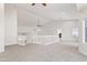 Neutral bonus room with vaulted ceiling, bright window, white staircase, and neutral carpet at 579 N Mondel Dr, Gilbert, AZ 85233