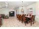 Large dining room featuring tile flooring, wainscoting, and abundant natural light creating a lovely ambiance at 579 N Mondel Dr, Gilbert, AZ 85233
