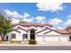 Impressive two-story home with a three-car garage, tile roof, and manicured front yard landscaping at 579 N Mondel Dr, Gilbert, AZ 85233