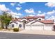 Beautiful two-story house featuring a terracotta roof, white stucco, three-car garage and desert landscaping at 579 N Mondel Dr, Gilbert, AZ 85233