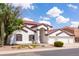 Charming two-story home with a terracotta roof, white stucco, and a desert-landscaped front yard at 579 N Mondel Dr, Gilbert, AZ 85233