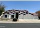 Charming two-story home with a three car garage, manicured lawn, and desert landscaping at 579 N Mondel Dr, Gilbert, AZ 85233