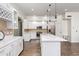 The bright kitchen features stainless steel appliances, white cabinetry, and a central island at 579 N Mondel Dr, Gilbert, AZ 85233