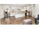 The bright kitchen features stainless steel appliances, white cabinetry, and a central island at 579 N Mondel Dr, Gilbert, AZ 85233