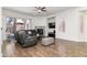 Comfortable living room offers wood floors, a cozy fireplace, and sliding glass doors to the outdoor living area at 579 N Mondel Dr, Gilbert, AZ 85233