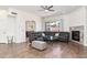 Spacious living room boasts beautiful wood floors, recessed lighting, and a fireplace, perfect for gatherings at 579 N Mondel Dr, Gilbert, AZ 85233