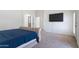 View of main bedroom's neutral carpet, plush bed, and access to ensuite bathroom at 579 N Mondel Dr, Gilbert, AZ 85233