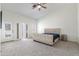 Bright main bedroom featuring vaulted ceiling, ceiling fan, and plush beige upholstered bed at 579 N Mondel Dr, Gilbert, AZ 85233