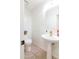 Clean powder room featuring pedestal sink, tiled floor, and modern fixtures at 579 N Mondel Dr, Gilbert, AZ 85233