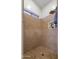 Shower features neutral tile, built-in shelving, rainfall shower head, and window at 579 N Mondel Dr, Gilbert, AZ 85233