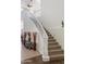 Beautiful staircase with white railings and a carpeted runner leading to the second floor at 579 N Mondel Dr, Gilbert, AZ 85233