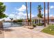 Tranquil waterfront property showcasing a lake with private docks, lush landscaping, and luxurious homes in the backdrop at 579 N Mondel Dr, Gilbert, AZ 85233