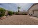 Gravel backyard with a palm tree, shrubbery, and a block wall at 5924 W Shangri La Rd, Glendale, AZ 85304