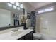 Bathroom with vanity, mirror, decor, and a tub with shower at 5924 W Shangri La Rd, Glendale, AZ 85304
