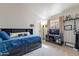 Bedroom with bed, carpet, ceiling fan, wall decorations, and a window at 5924 W Shangri La Rd, Glendale, AZ 85304