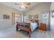 Bedroom with a wood sleigh bed frame, carpet, ceiling fan, and decor at 5924 W Shangri La Rd, Glendale, AZ 85304