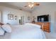 Primary bedroom featuring a wood sleigh bed frame, carpet, ceiling fan, dresser, and decor at 5924 W Shangri La Rd, Glendale, AZ 85304